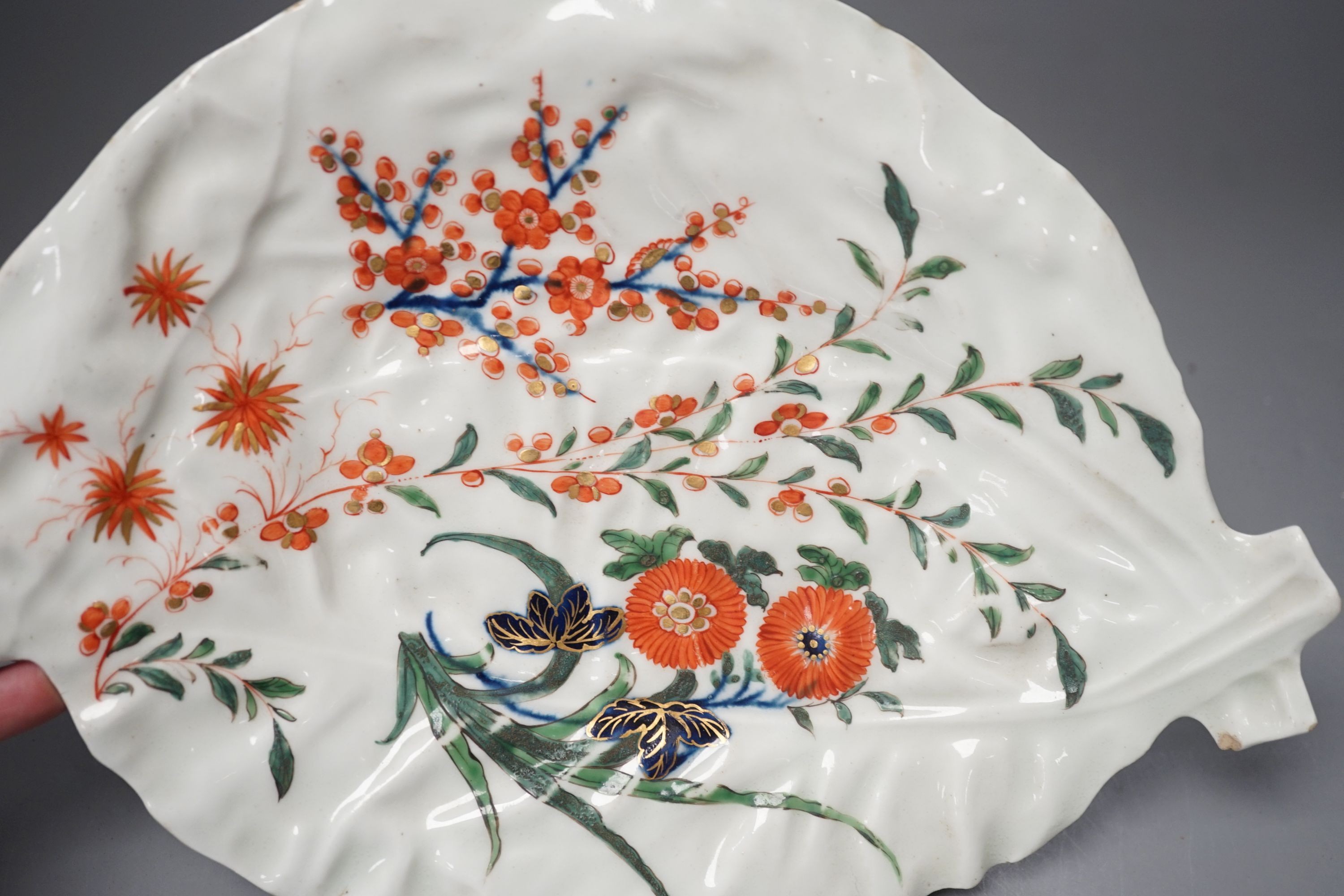 A Worcester leaf shaped dish of cos lettuce shape painted in Japanese kakiemon style with flowering plants c. 1768, 26 cms high.